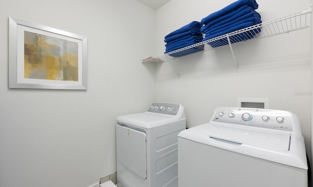 laundry area with independent washer and dryer