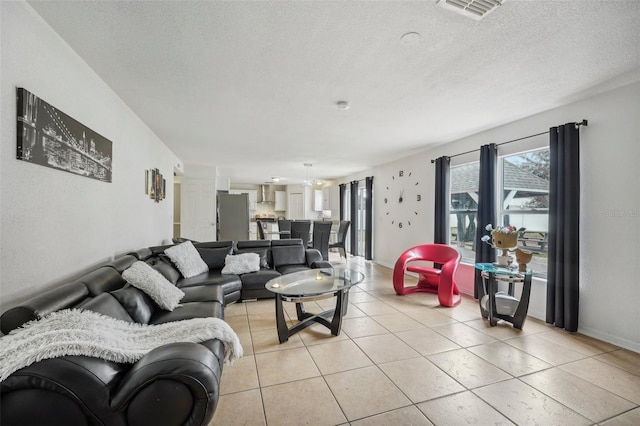 living room with light tile patterned floors and a textured ceiling