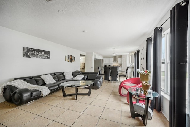 living room with light tile patterned flooring and a textured ceiling