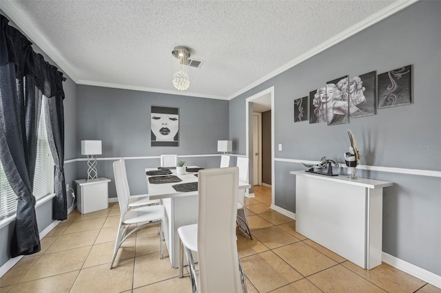 tiled dining space featuring crown molding and a textured ceiling