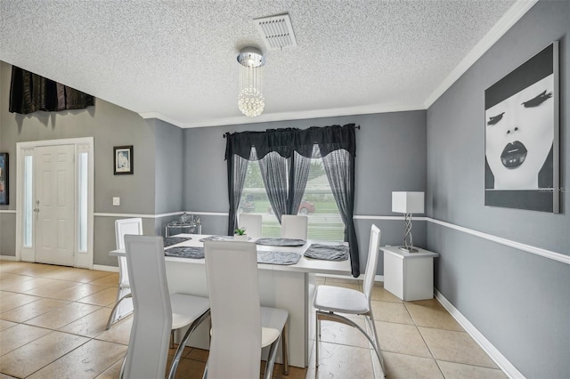 dining room featuring crown molding, light tile patterned floors, and a textured ceiling