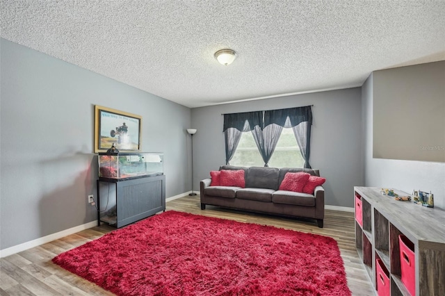 living room featuring hardwood / wood-style flooring and a textured ceiling