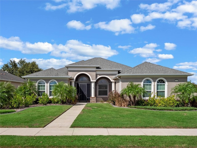 mediterranean / spanish home featuring a front yard