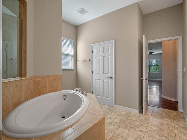 bathroom with tile patterned flooring, ceiling fan, a textured ceiling, and shower with separate bathtub