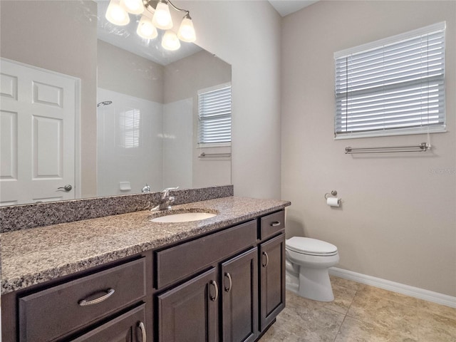 bathroom with vanity, a shower, toilet, and tile patterned floors