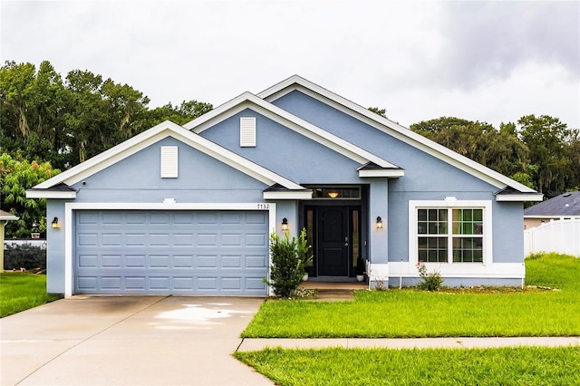 view of front of house featuring a front yard and a garage