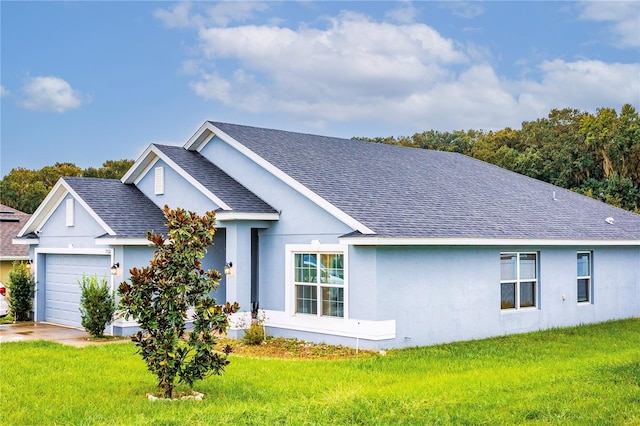 view of front facade with a garage and a front lawn