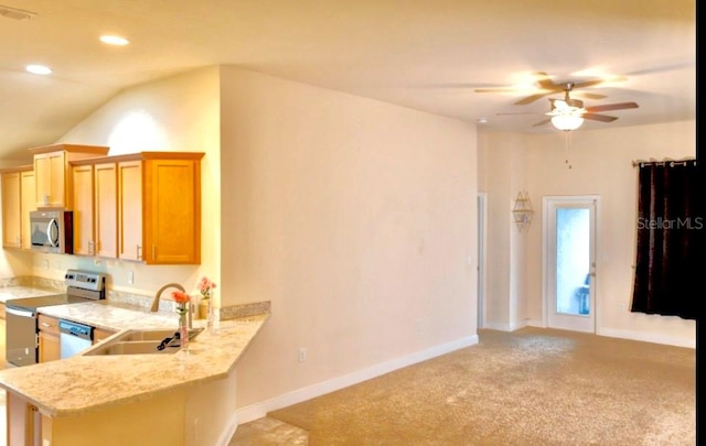 kitchen featuring ceiling fan, sink, vaulted ceiling, light carpet, and appliances with stainless steel finishes