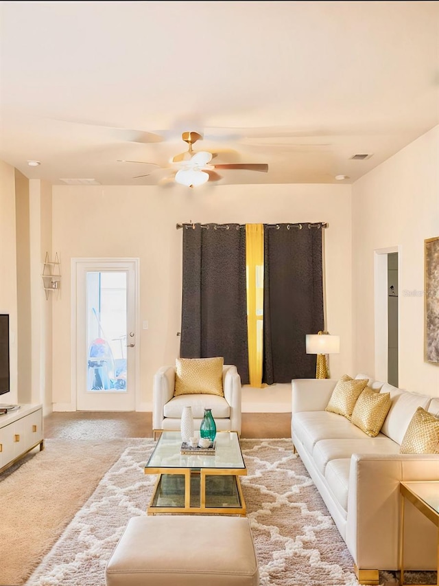 carpeted living room featuring ceiling fan