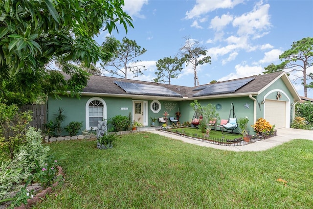 single story home with solar panels, a front lawn, and a garage