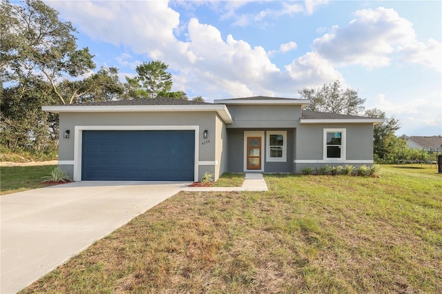 view of front of property with a front lawn and a garage