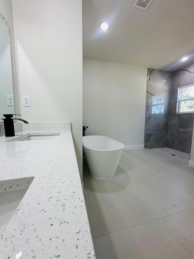 bathroom featuring vanity and shower with separate bathtub