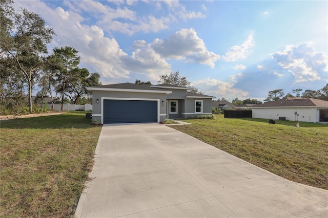 ranch-style house featuring a front yard and a garage