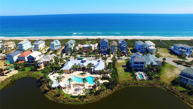 aerial view with a residential view, a water view, and a beach view