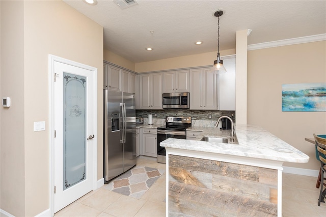 kitchen with a peninsula, gray cabinets, stainless steel appliances, and a sink