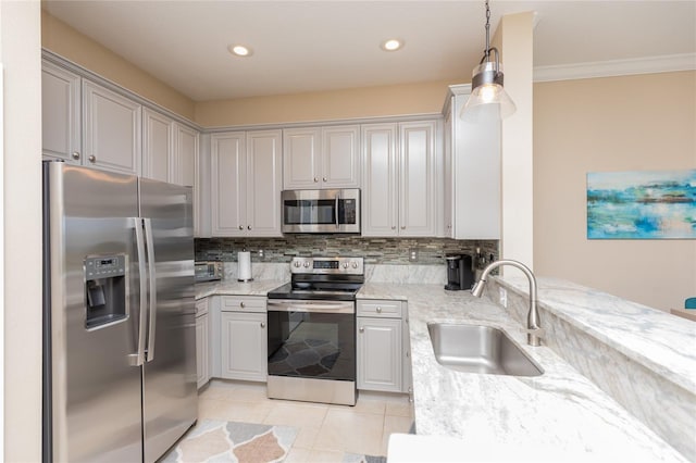 kitchen with light stone counters, tasteful backsplash, appliances with stainless steel finishes, light tile patterned flooring, and a sink