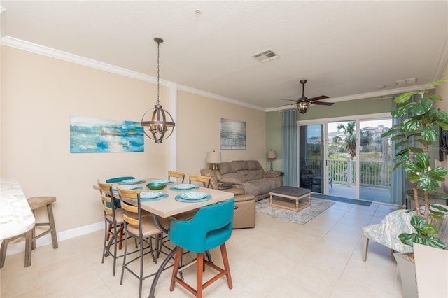 dining space with baseboards, ceiling fan with notable chandelier, visible vents, and ornamental molding