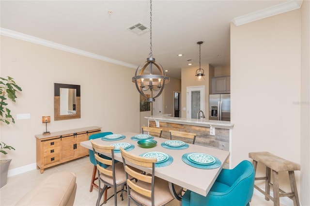 dining space featuring light tile patterned floors, visible vents, baseboards, ornamental molding, and an inviting chandelier