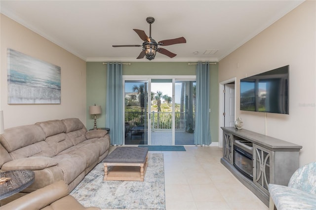 living room with light tile patterned floors, baseboards, a ceiling fan, and crown molding