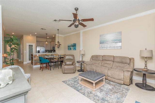 living room featuring light tile patterned floors, baseboards, visible vents, a ceiling fan, and ornamental molding