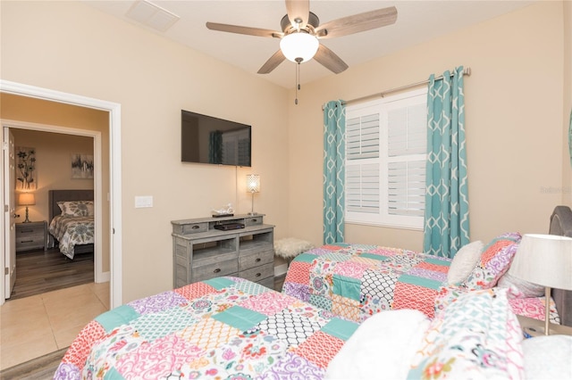 bedroom with tile patterned flooring, visible vents, and ceiling fan