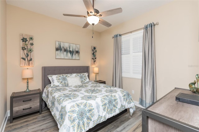 bedroom featuring baseboards, a ceiling fan, and wood finished floors