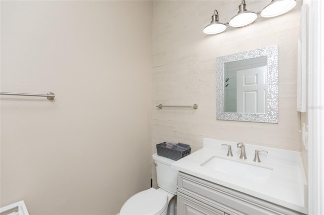 bathroom with toilet and vanity