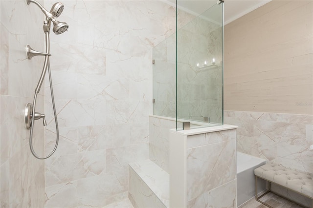 bathroom with ornamental molding, walk in shower, and tile walls