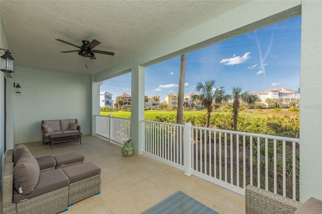 sunroom / solarium with ceiling fan and a residential view