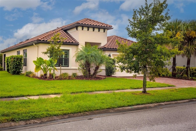 3951 Carrick Bend Dr, Kissimmee, FL 34746 - view of front facade featuring a tiled roof, decorative driveway, a front yard, an attached garage, and stucco siding