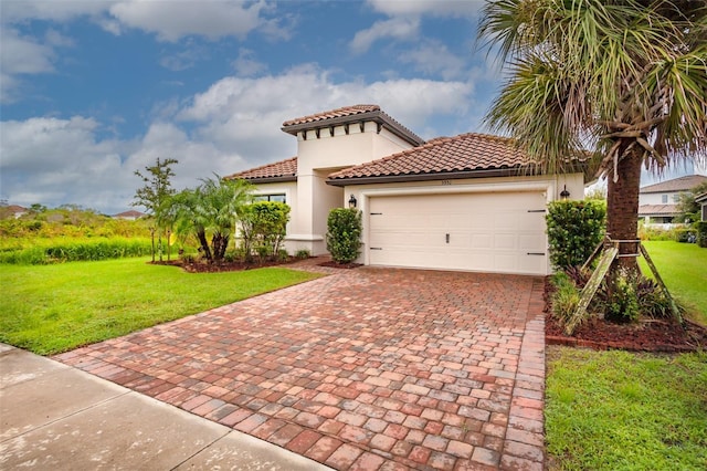 3951 Carrick Bend Dr, Kissimmee, FL 34746 - mediterranean / spanish-style house featuring stucco siding, decorative driveway, a garage, a tile roof, and a front lawn