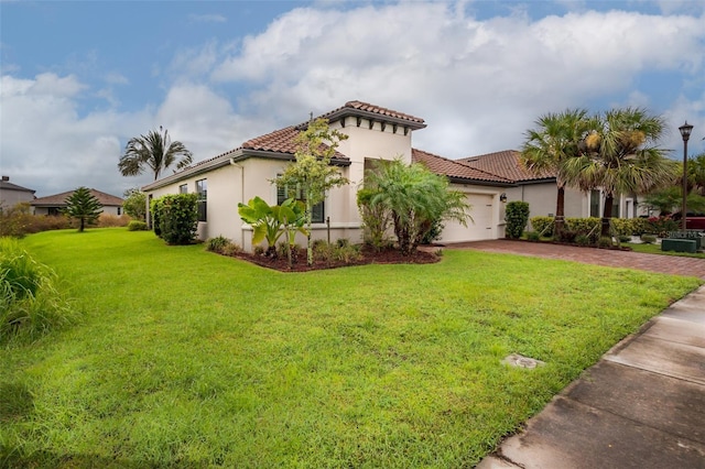 exterior space featuring a front lawn and a garage