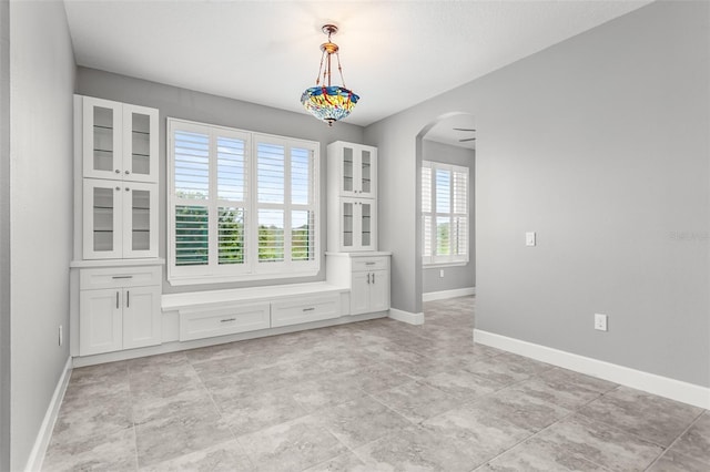 3951 Carrick Bend Dr, Kissimmee, FL 34746 - unfurnished dining area with arched walkways and baseboards