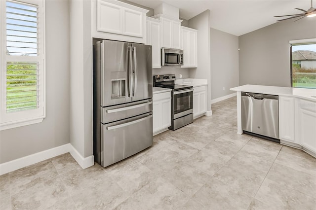 3951 Carrick Bend Dr, Kissimmee, FL 34746 - kitchen featuring white cabinets, a ceiling fan, appliances with stainless steel finishes, and light countertops