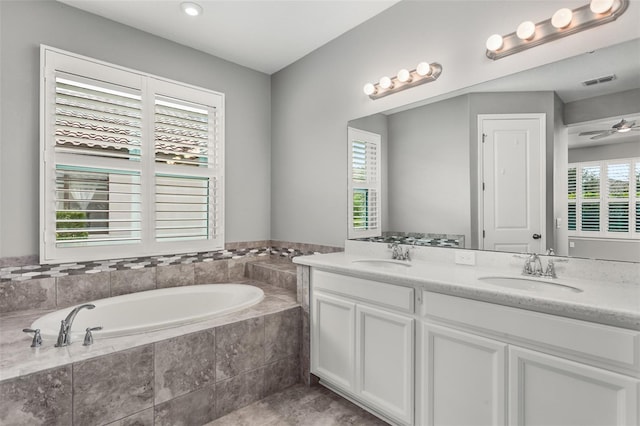3951 Carrick Bend Dr, Kissimmee, FL 34746 - full bath with double vanity, visible vents, a bath, and a sink