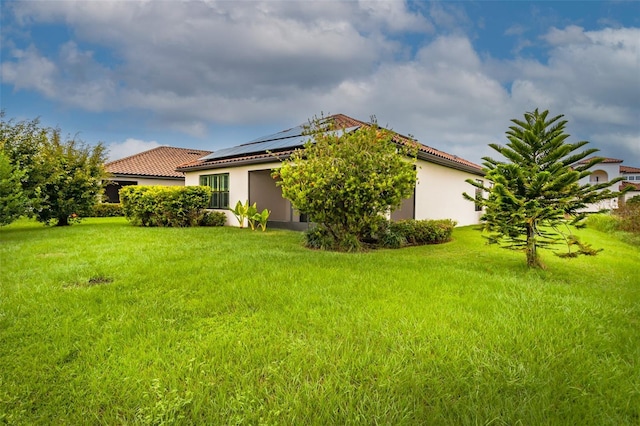 3951 Carrick Bend Dr, Kissimmee, FL 34746 - exterior space with a lawn, solar panels, a tiled roof, and stucco siding