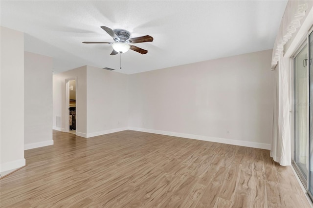 empty room with light hardwood / wood-style floors and ceiling fan