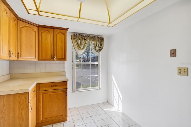 kitchen with decorative backsplash and light tile patterned floors