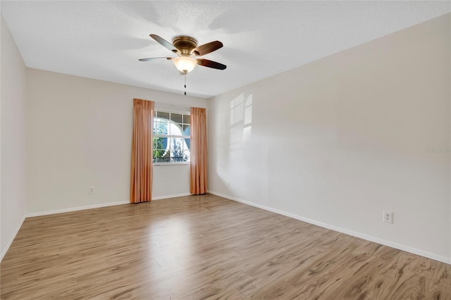 unfurnished room with light hardwood / wood-style floors, a textured ceiling, and ceiling fan