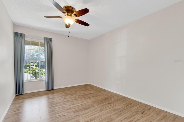 unfurnished room featuring ceiling fan, a textured ceiling, and light wood-type flooring