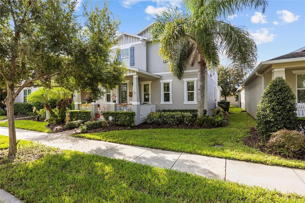 view of front facade featuring a front lawn and a porch