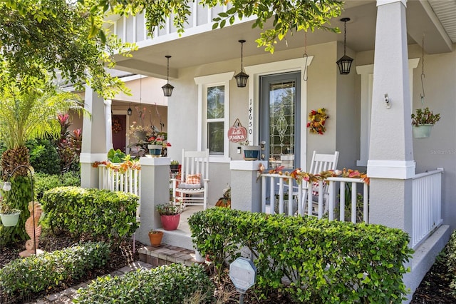 view of exterior entry with a porch