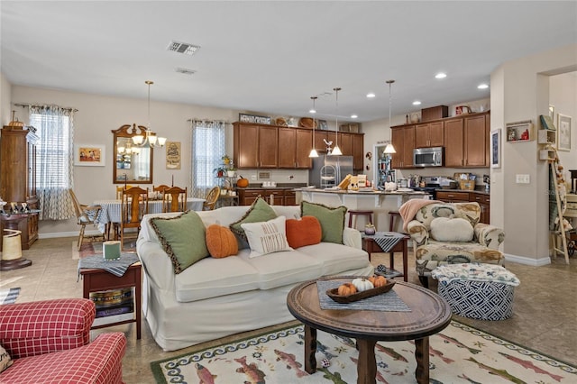 living room with a chandelier and light tile patterned floors