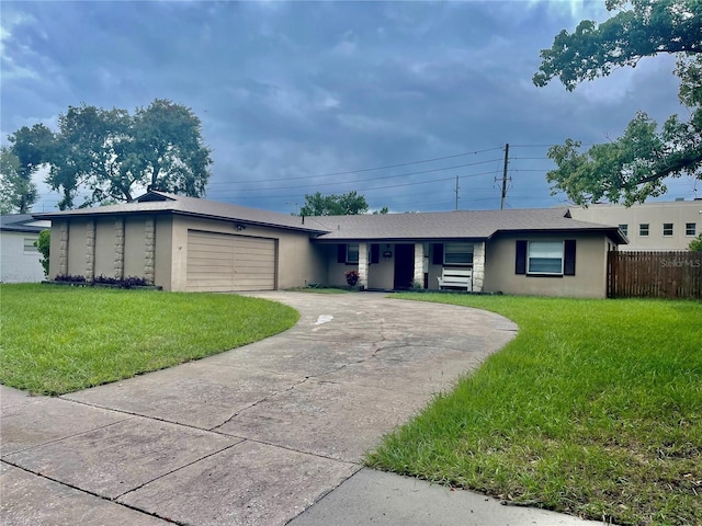 single story home featuring a front yard and a garage