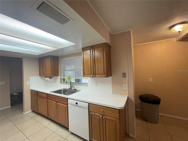 kitchen with dishwasher, crown molding, light tile patterned flooring, and sink