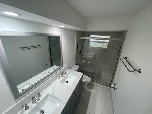 bathroom with walk in shower, vanity, toilet, and tile patterned floors