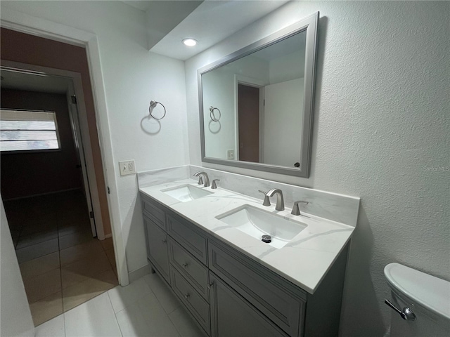 bathroom with vanity, tile patterned flooring, and toilet