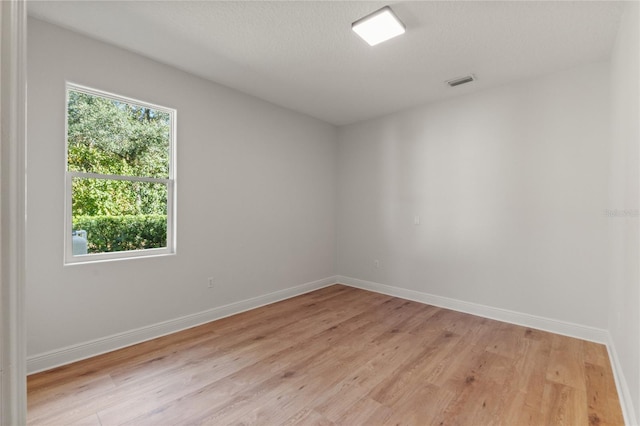 spare room featuring light hardwood / wood-style flooring