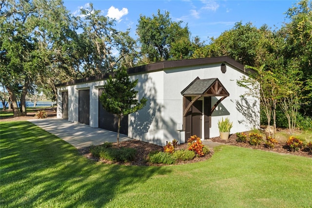 view of outdoor structure featuring a garage and a yard