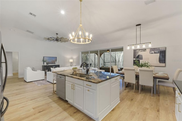 kitchen with white cabinetry, an island with sink, dishwasher, dark stone counters, and sink